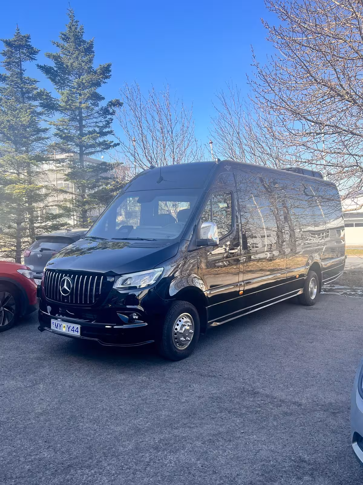 Black luxury Mercedes-Benz Sprinter van parked at Keflavik Airport for private transfer to Reykjavik