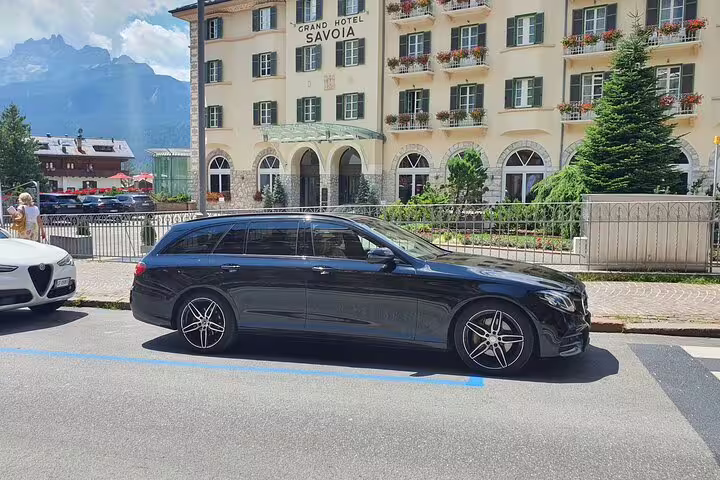 Sleek black Mercedes estate car parked near Grand Hotel for premium private transfer from Valencia Airport VLC