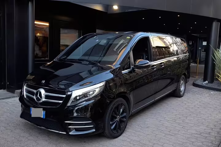 Sleek black Mercedes luxury van ready for private airport transfer service from Roatan RTB Airport.
