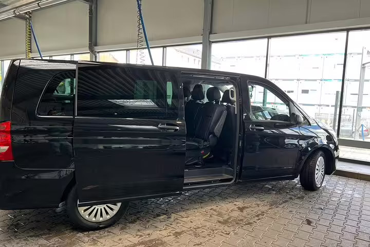 Black Mercedes-Benz V-Class van with open sliding door for private transfer service