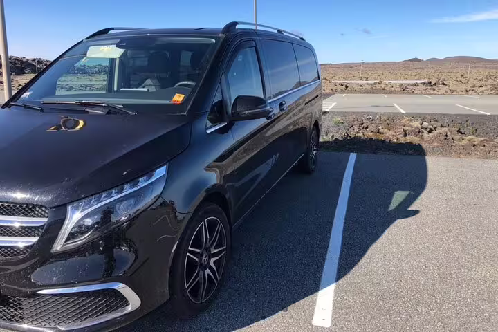 Black Mercedes V-Class minivan parked at Keflavik Airport transfer service in Iceland