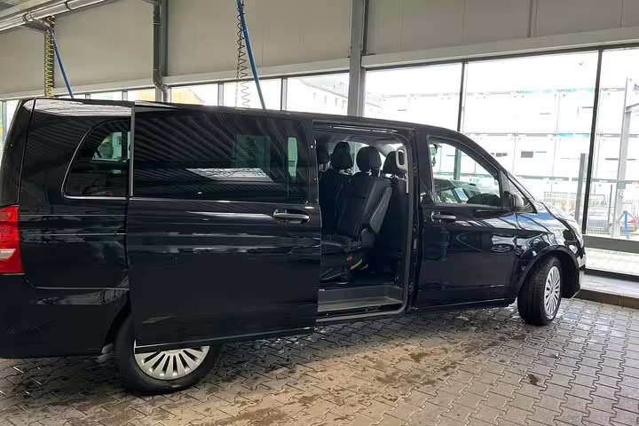 Black Mercedes-Benz Vito minivan with open sliding door for private transfer service