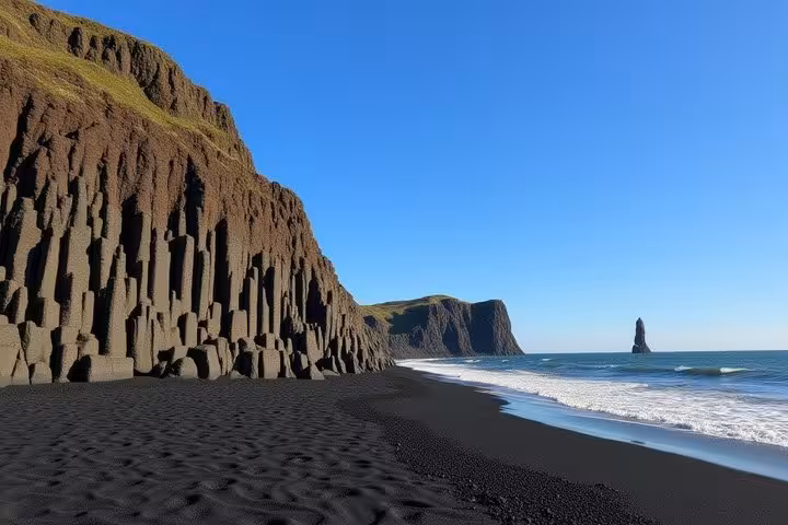 Black sand beach with basalt column cliffs and sea stack along Iceland's south coast