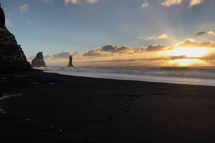 Black sand beach with sea stacks at golden sunset on Iceland's South Coast