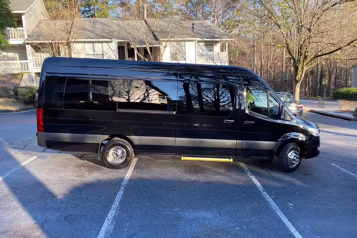 Black Mercedes Sprinter van parked in lot for private airport transfer service