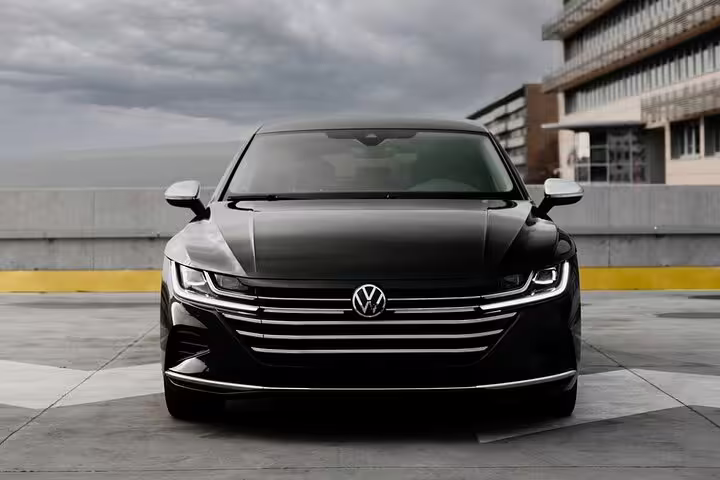 Black Volkswagen Arteon sedan front view for private chauffeur transfer Marseille to Milan