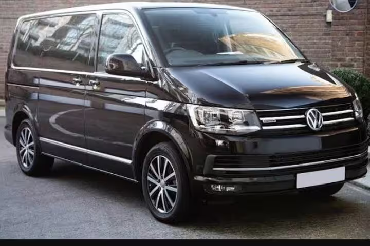 Black Volkswagen Transporter T6 minivan for private transfer Milan to Malpensa Airport