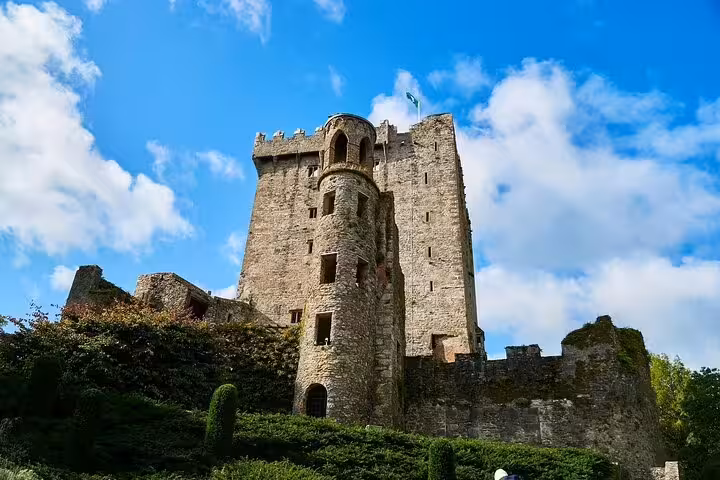 Blarney Castle stone tower in County Cork under blue skies, key stop on the Dublin to Cork City day trip