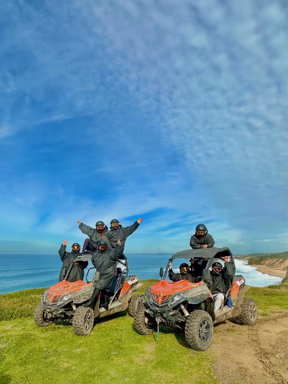 Group on two off-road buggies overlooking coastline on Blazing Trails Buggy Tour, guided adventure with helmets