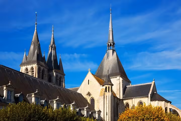 Medieval church spires and towers of Blois old town under a bright blue sky, Loire Valley, France