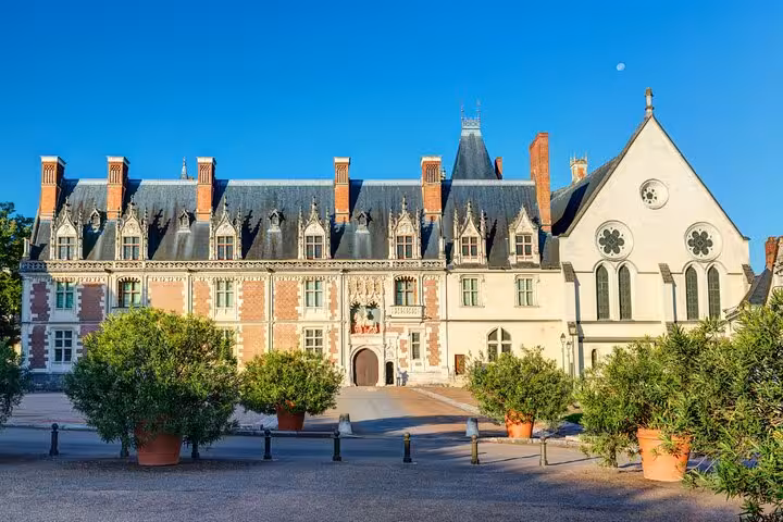 Château Royal de Blois facade with Gothic chapel and ornate Renaissance wing under blue sky