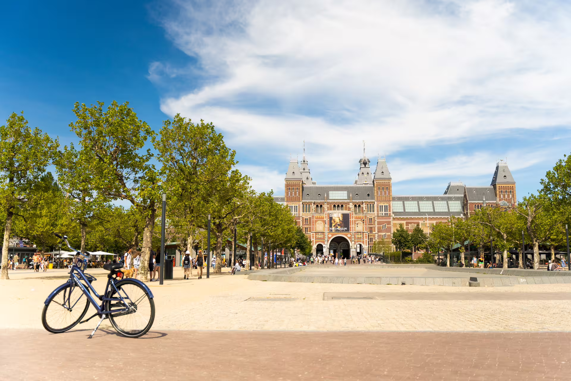 Blue bike parked near the iconic Rijksmuseum in Amsterdam, perfect for exploring the city with Amsterdam Rent a Bike.