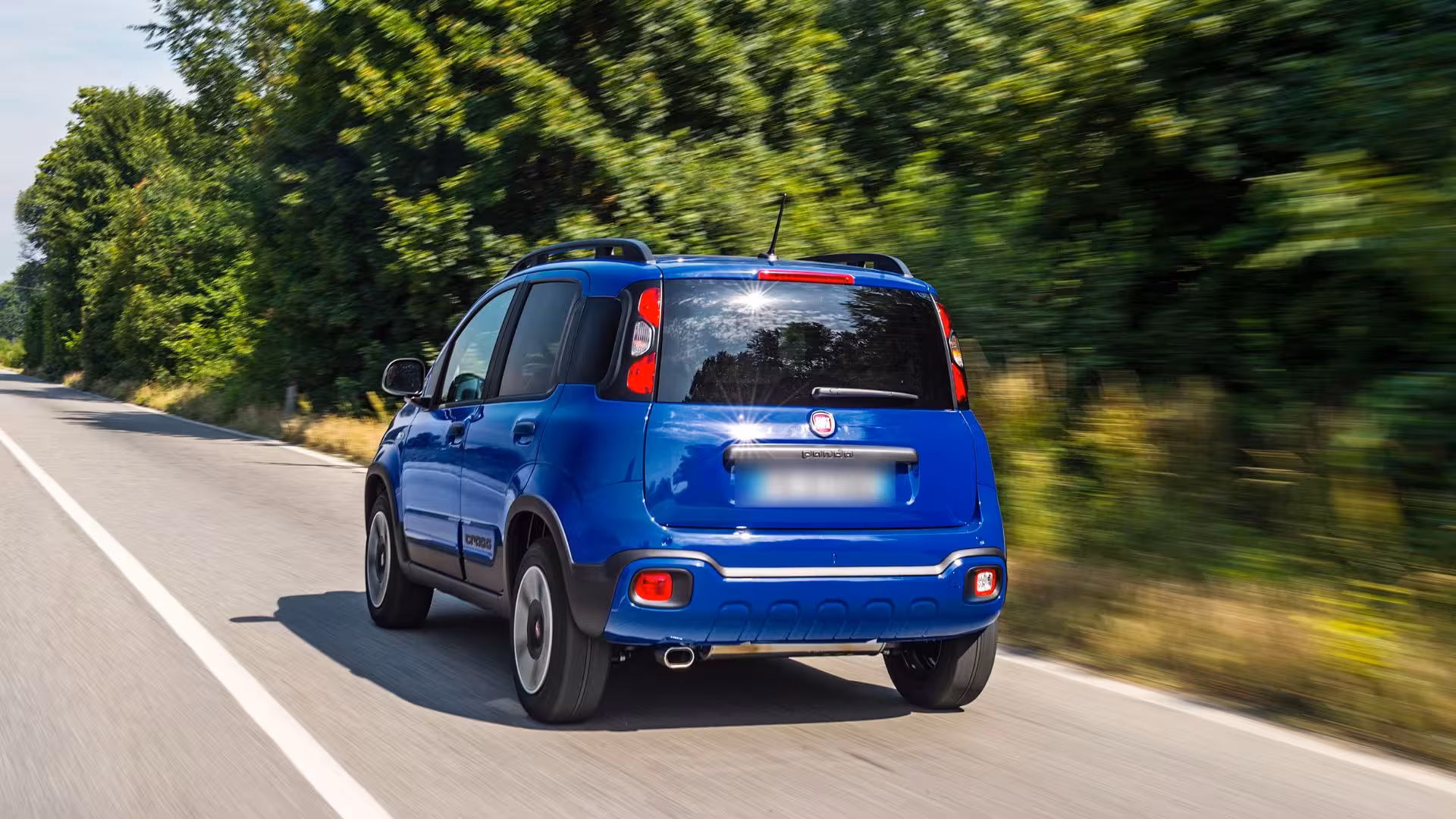 Blue car driving on a scenic road in Calasetta, perfect for exploring Sardinia with affordable car hire options.