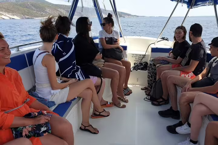 Small group relaxing on speedboat seats during Blue Cave and 5 Islands tour, cruising the Adriatic from Split