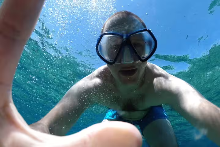 Underwater selfie while snorkeling on the Blue Cave & 5 Islands tour, clear Adriatic water and bubbles