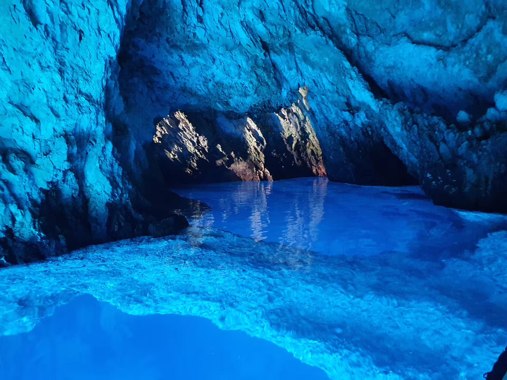 Glowing Blue Cave on Biševo Island with crystal Adriatic water, highlight of Vis and Hvar boat tour