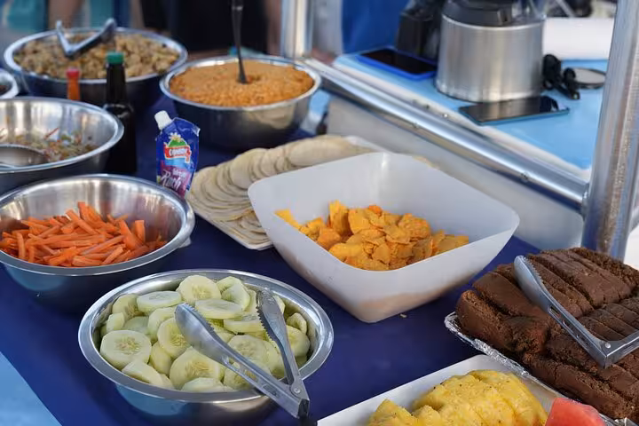 Vibrant buffet spread on Blue Dolphin Catamaran Tour featuring fresh fruits, vegetables, and snacks for guests.