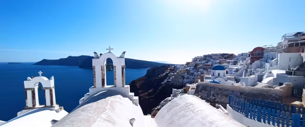 Blue-domed church rooftops in Fira Santorini with caldera views, a must-see stop on the highlights tour