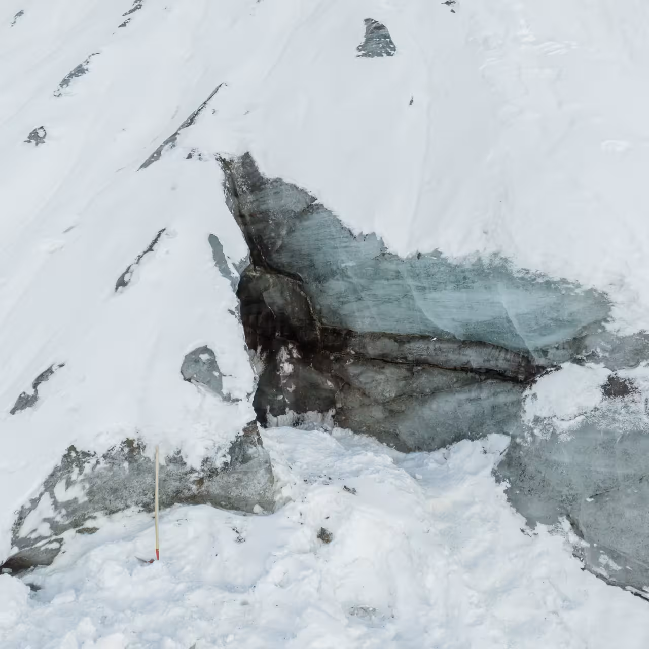 Close-up of layered blue glacial ice and snow crevasse on Myrdalsjokull glacier during Katla ice cave day trip from Vik