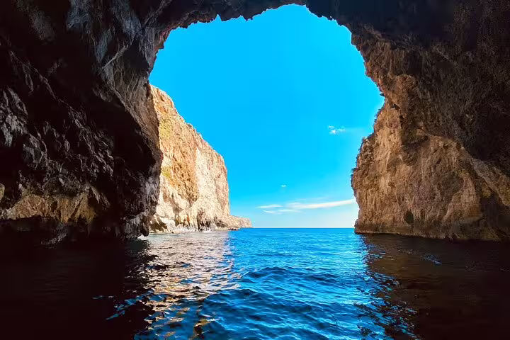 Stunning view from inside the Blue Grotto cave, showcasing crystal-clear Mediterranean waters and rocky cliffs in Malta.