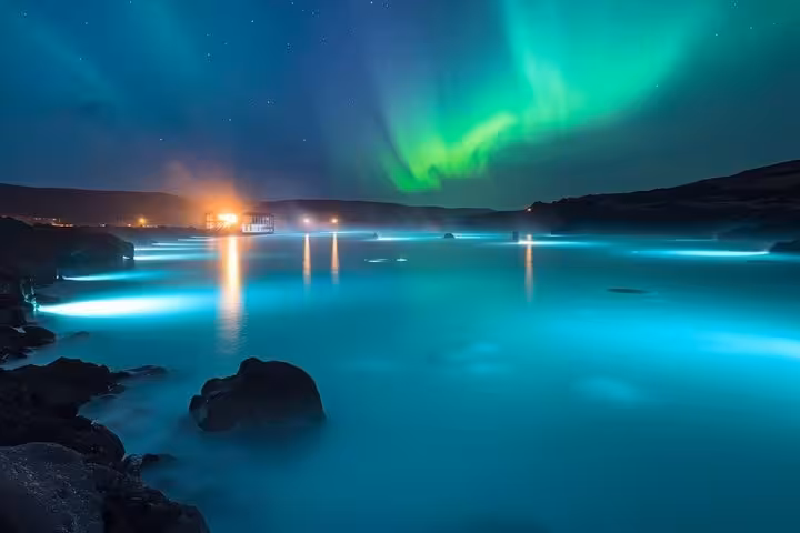 Aurora borealis glowing over Blue Lagoon geothermal waters at night near Reykjavik, Iceland