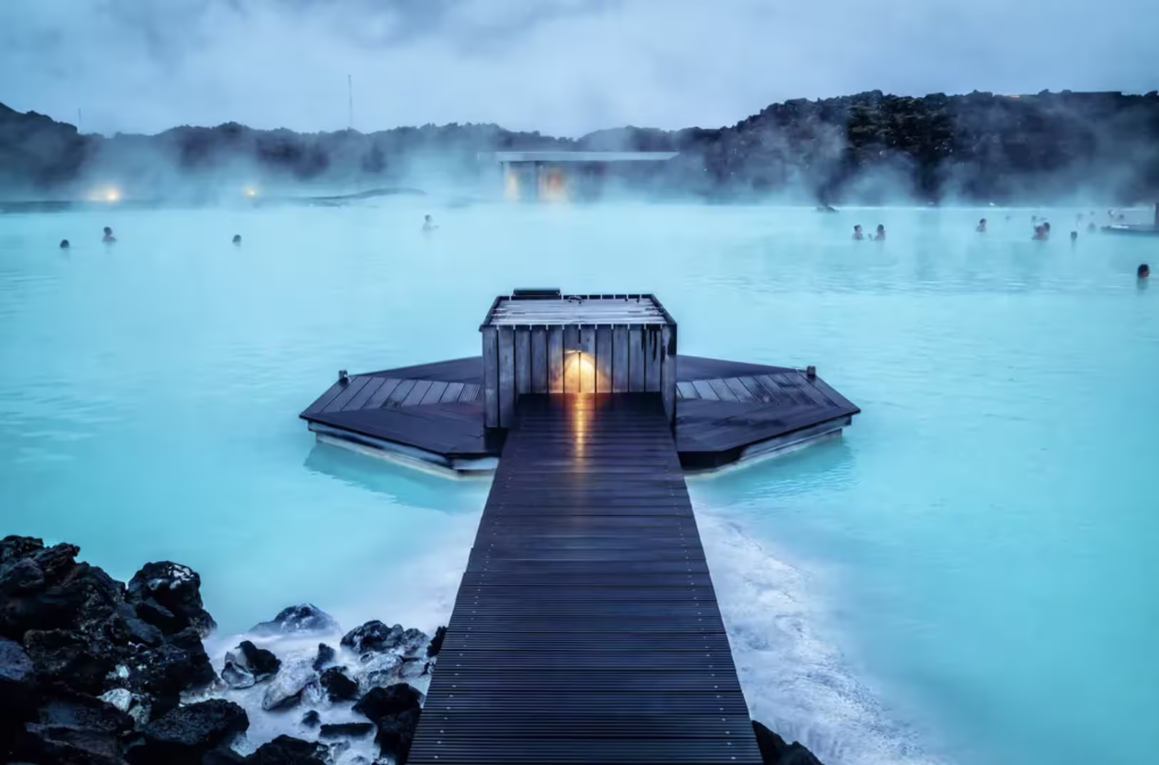 Blue Lagoon geothermal spa with steaming milky-blue waters, wooden boardwalk, and floating sauna in Reykjanes Peninsula, Iceland