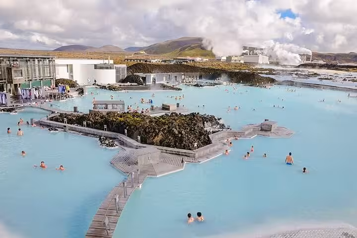Aerial view of Blue Lagoon geothermal spa with milky blue waters and bathers in Iceland