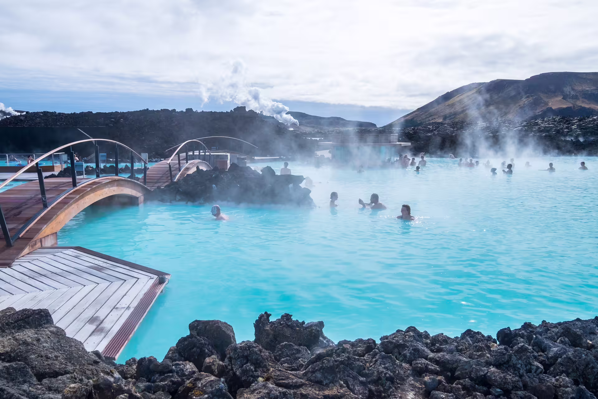 An image of the Blue Lagoon in Iceland with people taking a bath