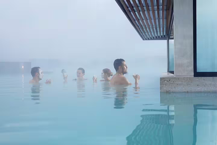 Visitors relaxing in the steamy blue geothermal waters of Blue Lagoon Iceland