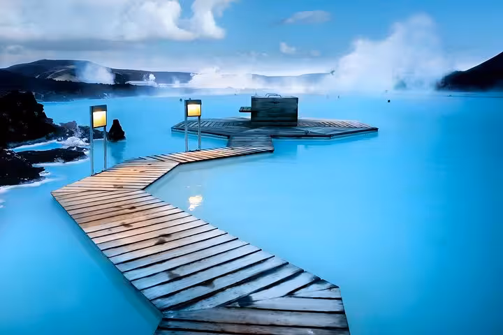 Blue Lagoon geothermal spa in Iceland with turquoise water, wooden boardwalk, and misty volcanic landscape