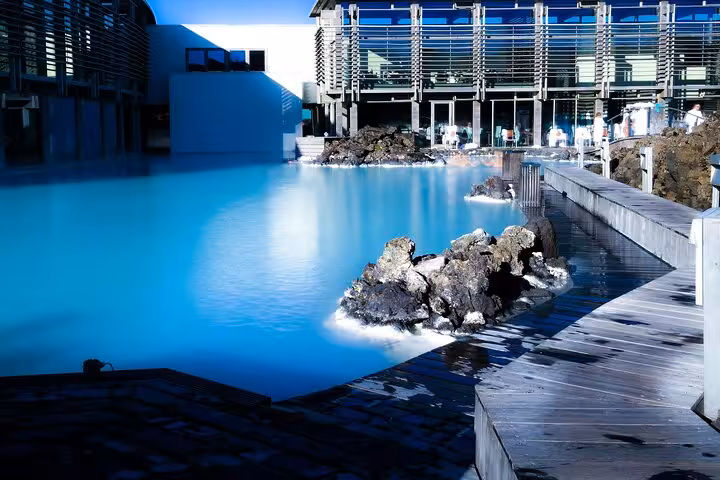 Blue Lagoon geothermal pool with milky blue water, volcanic rocks, and modern spa building in Iceland