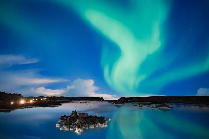 Aurora borealis dancing over Blue Lagoon geothermal waters at night in Iceland