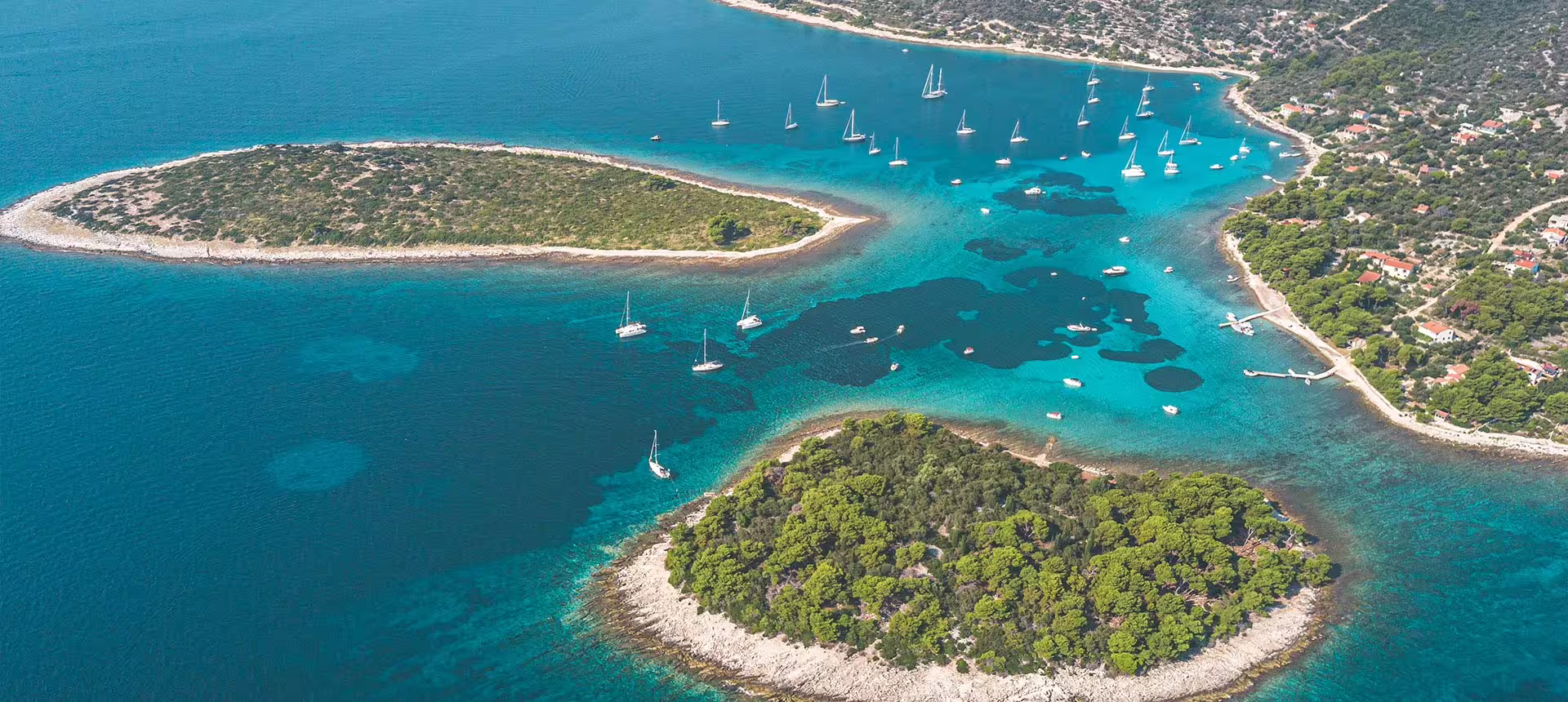 Aerial of Blue Lagoon Croatia with anchored sailboats and crystal-clear water, highlight of Solta private tour