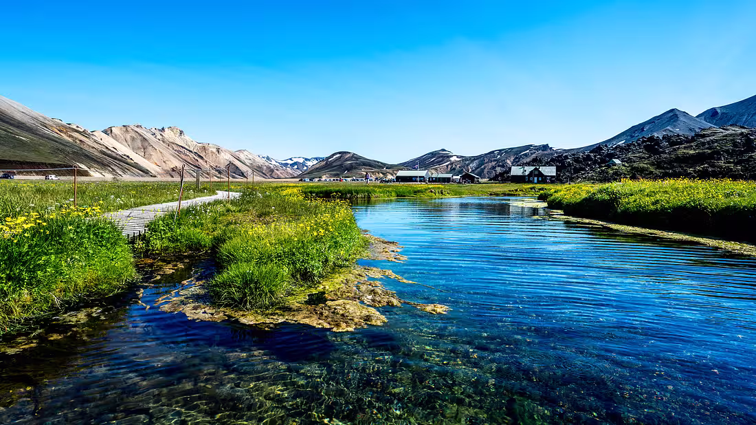 A small lake with beautiful blue water surrounded by lush nature