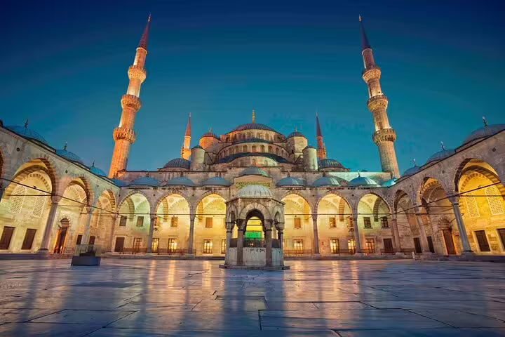 Stunning evening view of the illuminated Blue Mosque courtyard in Istanbul, perfect for guided private tours.