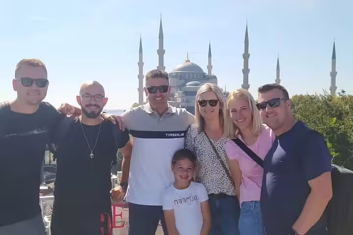 Group posing in front of the iconic Blue Mosque in Istanbul during a private guided tour.