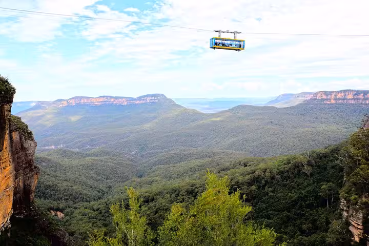 Blue Mountains scenic cable car ride offering breathtaking views of expansive valleys and rugged cliffs for group tours.