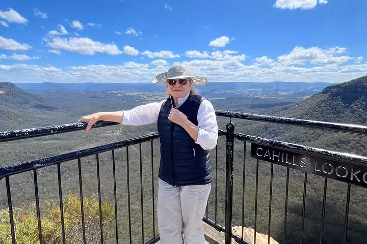 Visitor enjoys panoramic views at Cahills Lookout on Blue Mountains winery tasting private tour.