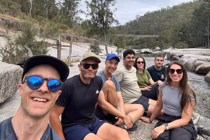 Group of hikers relaxing by a river in the Blue Mountains on a private guided tour.