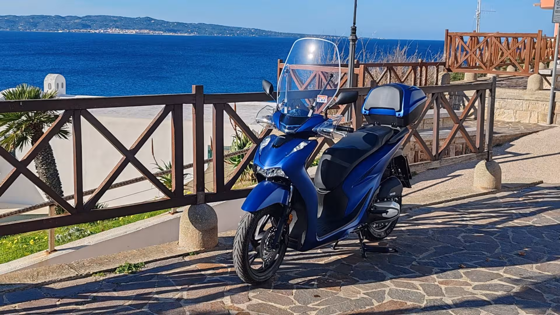 Stylish blue scooter available for hire in Calasetta, offering easy access to beautiful coastal roads and landscapes.