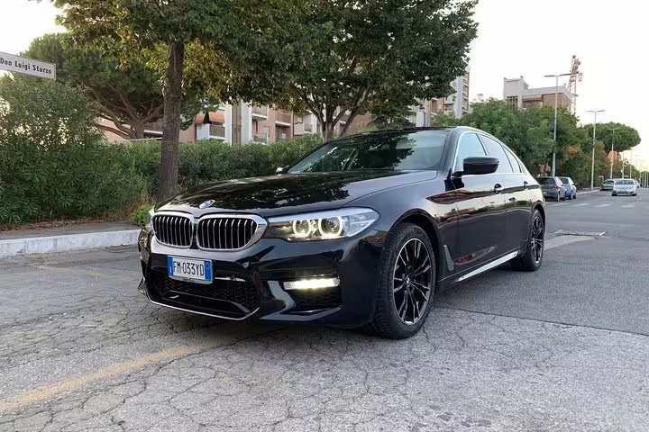 Sleek black BMW 5 Series sedan available for comfortable private transfer from Valencia Airport VLC to Valencia