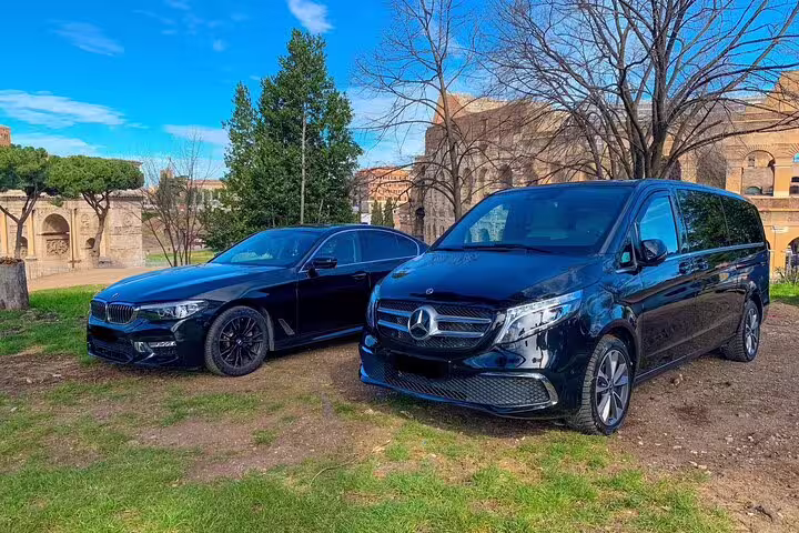 Black BMW sedan and Mercedes-Benz van ready for a private transfer from Amsterdam cruise port to The Hague