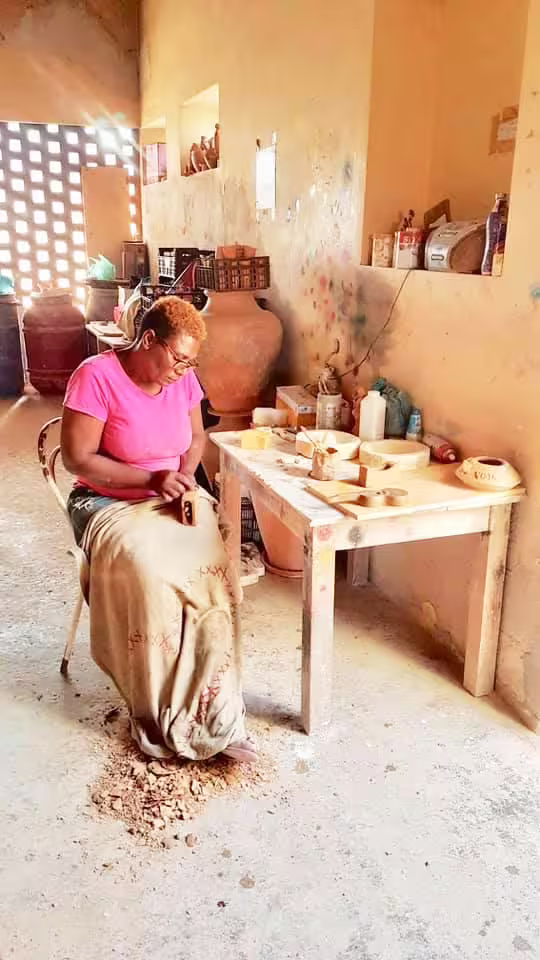 Local artisan carving wood in a traditional workshop on Boa Vista's cultural tour.