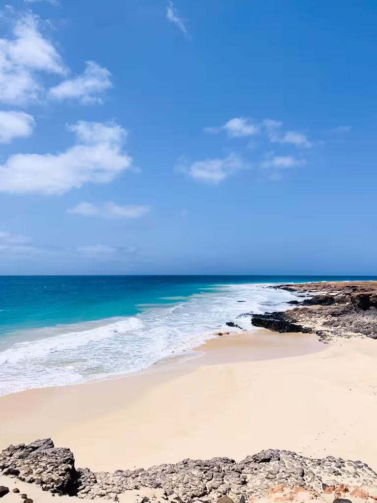 Secluded Boa Vista beach with turquoise water and rocky coast, stop on full-day wild beaches tour Cape Verde