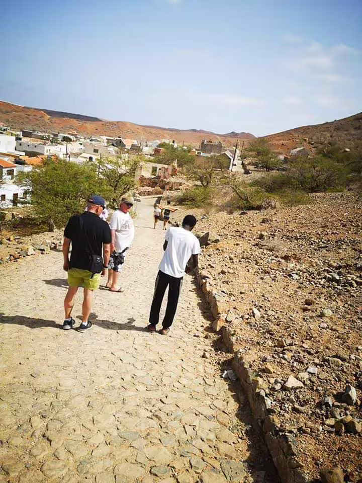 Tourists explore the rustic desert village in Boa Vista, capturing the authentic charm of local life and landscapes.