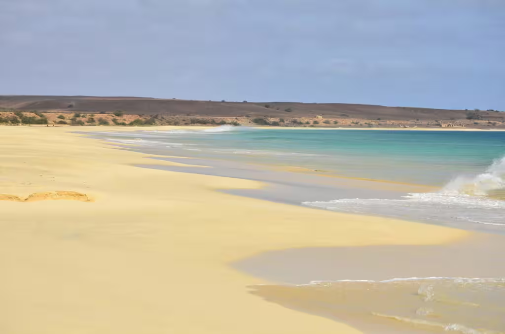 Waves gently lap onto the golden sands of Santa Monica beach, showcasing Boa Vista Island's natural beauty.