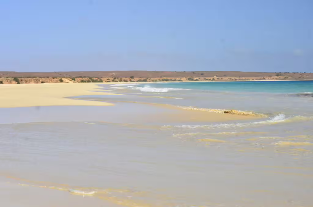 Vast coastal view of Santa Monica Beach with rolling waves and sandy shores on Boa Vista Island's quad tour route.