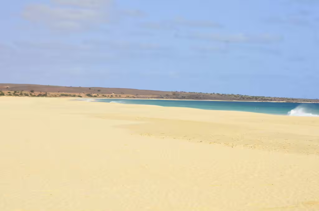 Expansive view of Santa Monica beach's pristine sands and turquoise waters on Boa Vista Island.