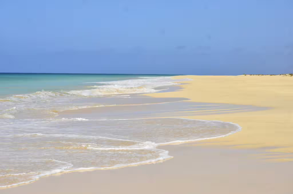 Pristine Santa Monica Beach on Boa Vista Island with golden sands and turquoise waters ideal for quad tours.