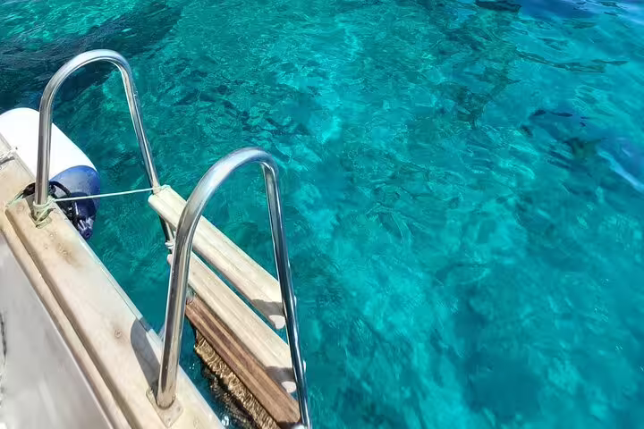 Boat ladder over turquoise water for a refreshing swim stop on a 4-hour private classic Capri tour